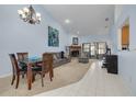 Spacious living room featuring a fireplace and access to the patio at 3985 Mermoor Dr, Palm Harbor, FL 34685