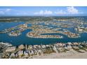 Wide aerial shot showcasing waterfront real estate in Treasure Island, Florida, offering stunning bay views at 10128 Paradise Blvd, Treasure Island, FL 33706