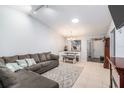 Comfortable living room offering tiled floors, neutral decor, and an open dining space at 106 Edgewood Ct, Oldsmar, FL 34677