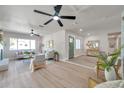 Bright and airy living room featuring modern furnishings, stylish decor, and a seamless flow to the entryway at 11712 128Th Ave, Largo, FL 33778