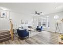Bright living room featuring wood floors, a ceiling fan, neutral paint, and a cozy seating area with a bay window at 2794 Countryside Blvd # 1, Clearwater, FL 33761