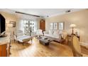 Bright living room with hardwood floors, comfortable white furniture, and large windows offering city views at 275 Bayshore Blvd # 408, Tampa, FL 33606