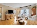 Cozy living room featuring wood floors, a decorative cabinet, and ample natural light from a large window at 275 Bayshore Blvd # 408, Tampa, FL 33606