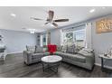 Bright living room with gray seating, a marble coffee table, and large windows at 1203 Desmond St, Port Charlotte, FL 33952