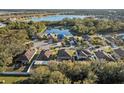 A stunning aerial view of the neighborhood homes around a beautiful lake surrounded by verdant trees at 2307 Dakota Rock Dr, Ruskin, FL 33570
