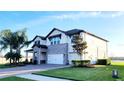 Attractive home with a combination of stone and siding, with a well-manicured lawn at 18304 Roseate Dr, Lutz, FL 33558