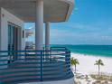 Balcony view of the beach with blue railing, perfect for relaxing and enjoying the scenery at 3910 Gulf Blvd # 400, St Pete Beach, FL 33706