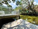 Dock featuring a metal ladder for easy access to the clear waterway at 7418 Bay Dr, Tampa, FL 33635