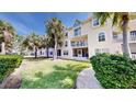 Charming condo with well-maintained lawn and mature palm trees enhancing the curb appeal at 443 Pinellas Bayway S # 105, Tierra Verde, FL 33715