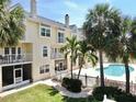 Attractive condo with well-manicured lawn, community pool, and screened lanai at 443 Pinellas Bayway S # 105, Tierra Verde, FL 33715