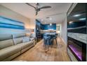 Stylish living area with a modern kitchen, island seating, and a cozy fireplace beneath a flatscreen TV at 8565 W Gulf Blvd # 17S, Treasure Island, FL 33706