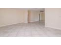 Bright and spacious living room featuring neutral tile flooring and an open layout at 10118 Hickory Hill, Port Richey, FL 34668