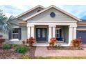 Charming single-story home featuring a covered front porch, well-maintained landscaping and an attached garage at 14214 Quintessa Ln, Lithia, FL 33547