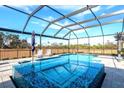 Beautiful in-ground pool and spa with a screened-in enclosure and plenty of space for entertaining at 14214 Quintessa Ln, Lithia, FL 33547