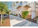 Well maintained Domus Urbana building entrance with a sidewalk, shrubbery and a tree at 644 3Rd S Ave # 305, St Petersburg, FL 33701