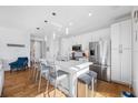 Bright, open kitchen with stainless steel appliances, white cabinets, and a large quartz island at 644 3Rd S Ave # 305, St Petersburg, FL 33701
