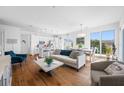 Bright open concept living space with hardwood floors, neutral furniture, and lots of natural light at 644 3Rd S Ave # 305, St Petersburg, FL 33701