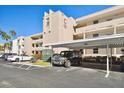 Exterior view of the The Bahamas Park condos showcasing covered parking and well-maintained landscaping at 7425 Bay Island S Dr # 104, South Pasadena, FL 33707