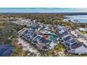 Aerial view of townhomes by lake with community pool and parking at 12189 Armenia Gables Cir # 12189, Tampa, FL 33612