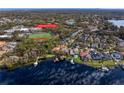 Stunning aerial view of a lakefront home with boat docks near Carrollwood Day School, offering serene waterfront living at 1903 Haven Bend, Tampa, FL 33613