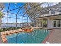 Screened-in pool features a hot tub and beautiful views of the lake at 1903 Haven Bend, Tampa, FL 33613