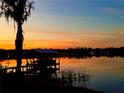 Scenic waterfront home with a private dock and covered boat lift featuring stunning sunset views at 1903 Haven Bend, Tampa, FL 33613