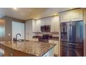 Bright kitchen with stainless steel appliances, granite counters, and white cabinets at 200 4Th S Ave # 139, St Petersburg, FL 33701