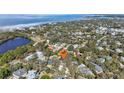 An aerial view of a neighborhood showcasing its proximity to the water and lush surroundings at 363 Sanctuary Dr, Crystal Beach, FL 34681