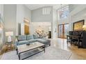 Sun-drenched living room with high ceilings, a comfortable sofa, and an adjacent dining area at 363 Sanctuary Dr, Crystal Beach, FL 34681