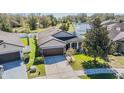 Beautiful home features manicured landscaping, large trees, and a spacious driveway at 714 Sugar Camp Way, Brooksville, FL 34604
