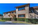 Exterior view showcasing the building's facade and the surrounding manicured greenery under a bright blue sky at 8005 Bardmoor Pl # 202I, Seminole, FL 33777