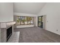Inviting living area features a fireplace, sliding glass doors leading to outdoor space and ample natural light at 8005 Bardmoor Pl # 202I, Seminole, FL 33777