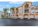 Exterior of a multi-story condo building with private garages and screened balconies at 1203 Bay Club Cir # 1203, Tampa, FL 33607