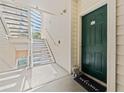 Inviting entrance with a green front door, welcome mat, and a decorative statue, creating a warm and welcoming atmosphere at 1203 Bay Club Cir # 1203, Tampa, FL 33607