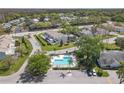Beautiful aerial view of a residential community with a pool and well-maintained landscaping at 16211 Rambling Vine W Dr, Tampa, FL 33624