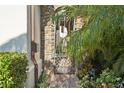 Charming courtyard entrance with brick pavers, decorative gate, and lush greenery at 801 Brightwaters Ne Blvd, St Petersburg, FL 33704
