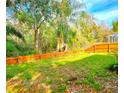 A spacious backyard featuring lush greenery and a wooden fence, perfect for outdoor enjoyment at 10232 Grant Creek Dr, Tampa, FL 33647