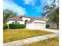 Charming single-story home with a well-manicured lawn and two car garage at 10232 Grant Creek Dr, Tampa, FL 33647