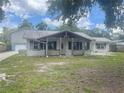 Charming single-story home featuring a welcoming front porch and a durable metal roof at 34799 Evergreen Way, Dade City, FL 33523