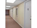 Hallway view features neutral paint and carpet in a building offering waterfront living at 420 64Th Ave # 1005, St Pete Beach, FL 33706