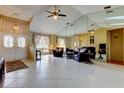Bright living room with tile flooring, ceiling fan, and sliding glass doors at 4728 Swallowtail Dr, New Port Richey, FL 34653