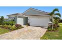Charming single-story home featuring a two-car garage, paver driveway, and beautifully landscaped front yard at 11683 Rose Gold Ct, Venice, FL 34293