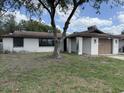 A single-story home with a brown roof and an attached one car garage; roofing supplies are visible at 12812 1St Isle, Hudson, FL 34667