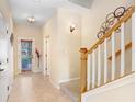 Bright foyer boasts tile flooring, modern decor, and staircase at 310 Summer Clouds Pl, Brandon, FL 33511