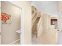 Inviting entryway features tile flooring, staircase, half bath, and neutral color scheme at 310 Summer Clouds Pl, Brandon, FL 33511