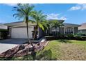 Charming home with a two-car garage, landscaped yard, and palm trees at 3110 Bent Creek Dr, Valrico, FL 33596