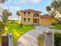 Beautiful two-story home featuring mature landscaping, a two-car garage, and inviting curb appeal at 316 Shore E Dr, Oldsmar, FL 34677