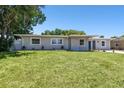 Well-maintained single-story home featuring new landscaping and a neatly manicured front lawn at 4004 W Coachman Ave, Tampa, FL 33611