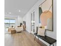 Bright and airy living room with lake views and modern décor at 11341 Hardwood Hammock Ln, Riverview, FL 33569