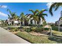 Beautiful home featuring tropical landscaping, a brick driveway and an attached garage at 17014 Clear Cork Dr, Wimauma, FL 33598
